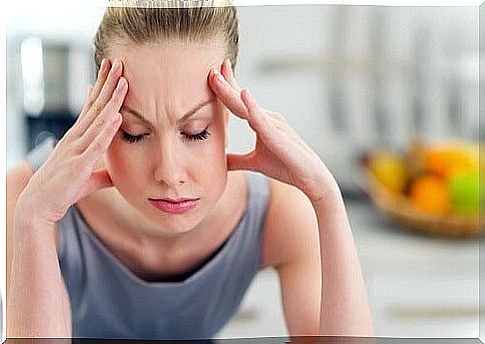 Stressed woman with her hands on her head.