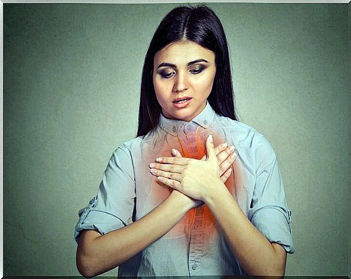 Woman with her hands on her chest where there is a drawing of her respiratory tract.