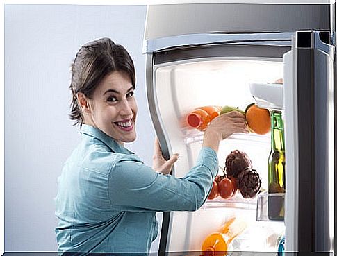 woman putting food in the fridge