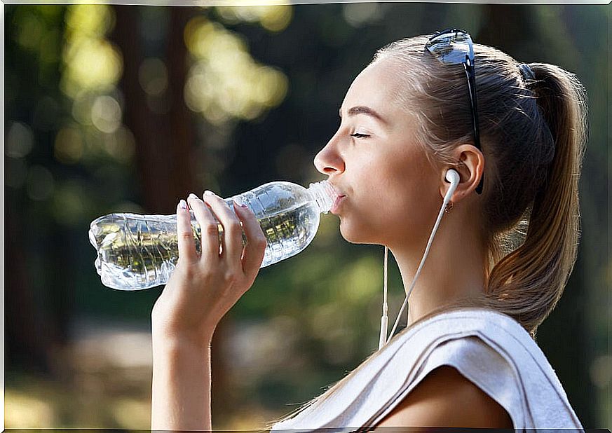 Girl drinking water from a bottle.