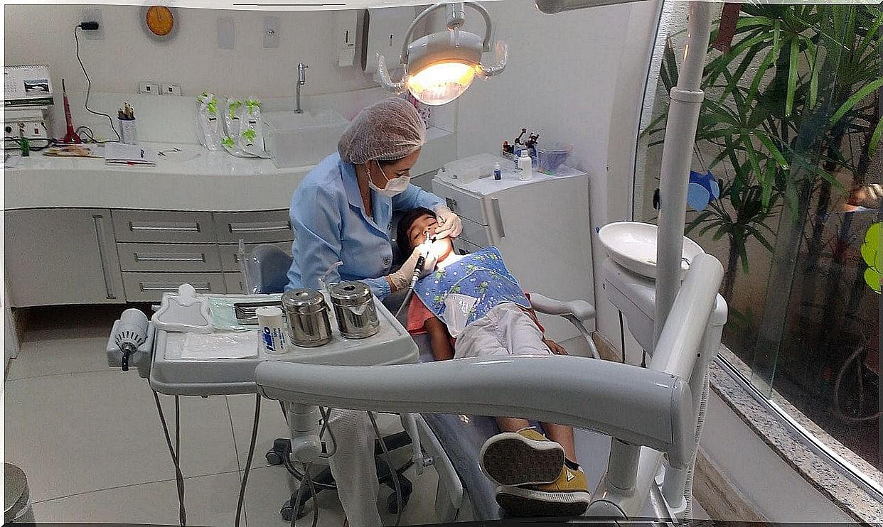 Dentist with a child on the gurney.