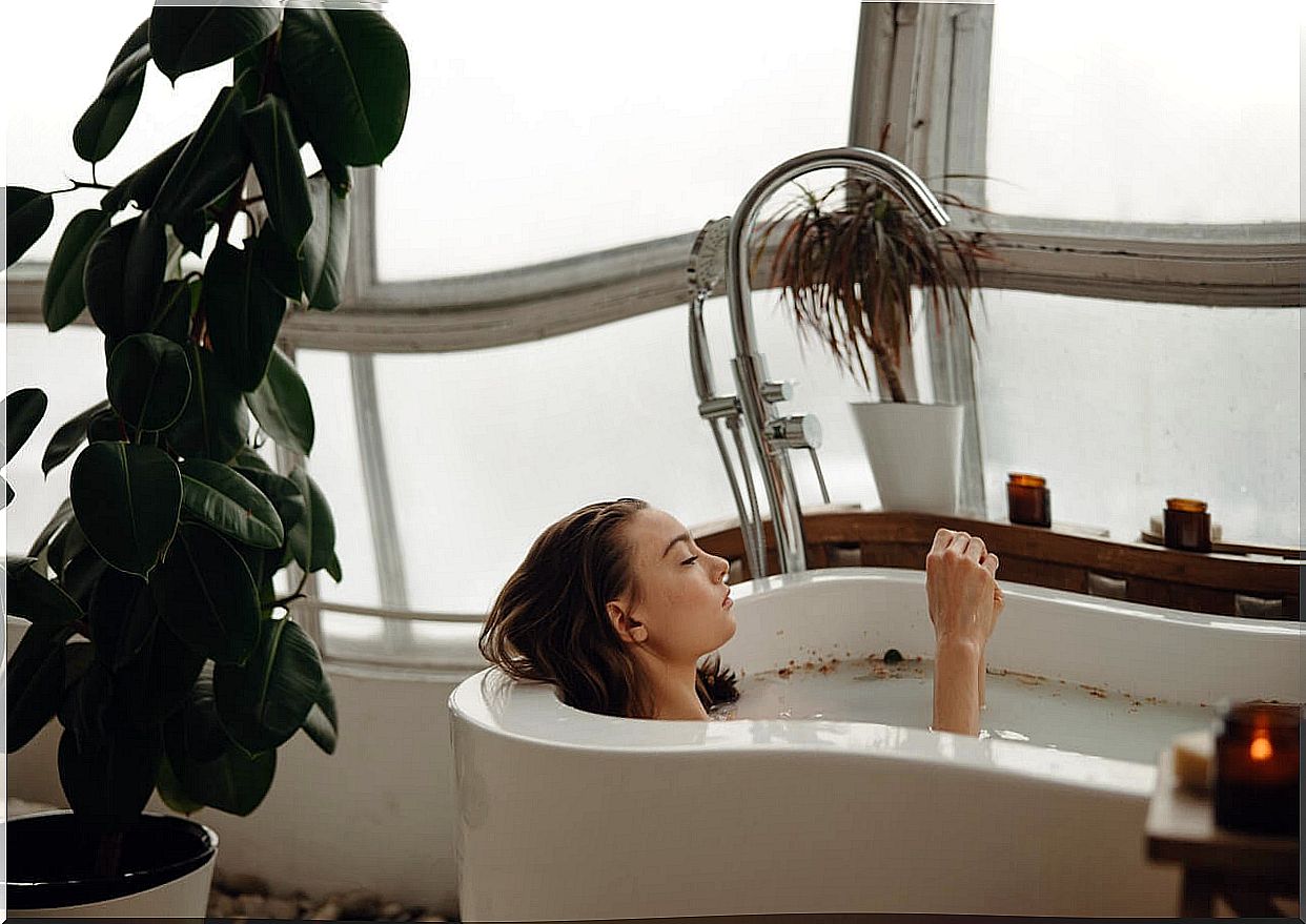 Woman taking a hot bath to relax.