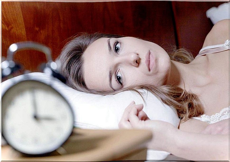 Woman with wide eyes in bed