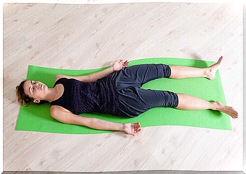 Woman lying on the floor on a sports mat