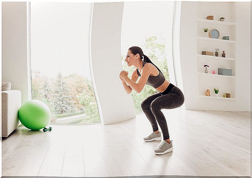 Woman doing squats at home.