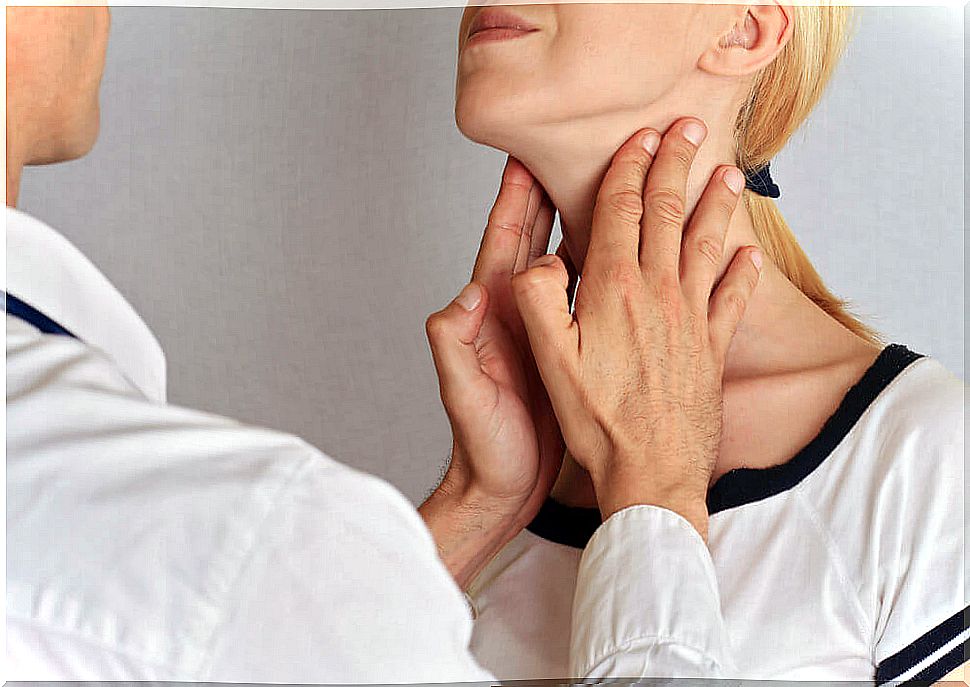 Doctor palpating nodules on the neck.