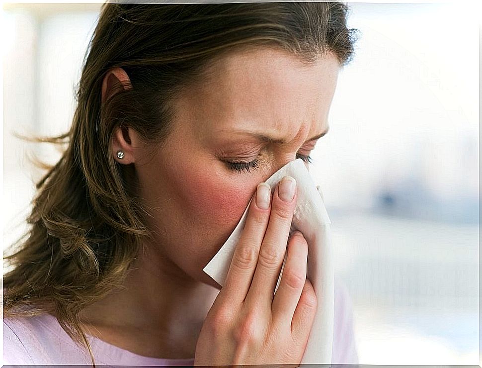 Woman blowing her nose with a handkerchief.