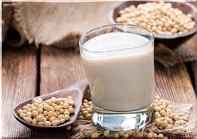 Glass with soy milk and spoon with seeds