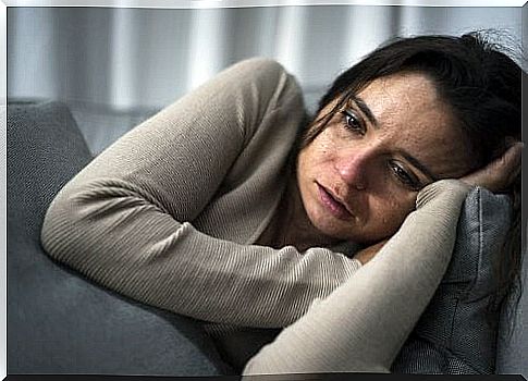 Woman lying in an armchair with depression